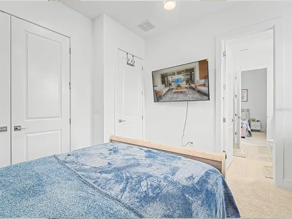 a living room with furniture a dining table and a chandelier