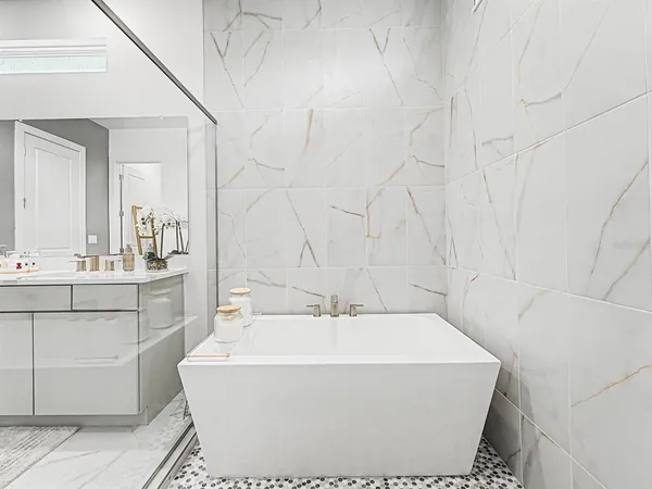 a living room with furniture and a view of kitchen
