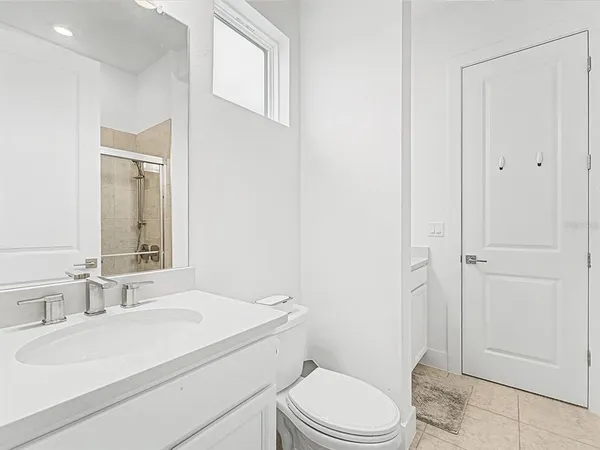 a view of a bathroom with a tub sink and mirror
