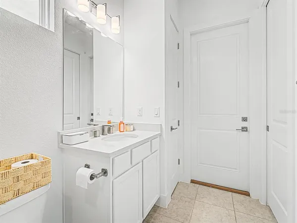 a view of a bedroom with a bed and a window