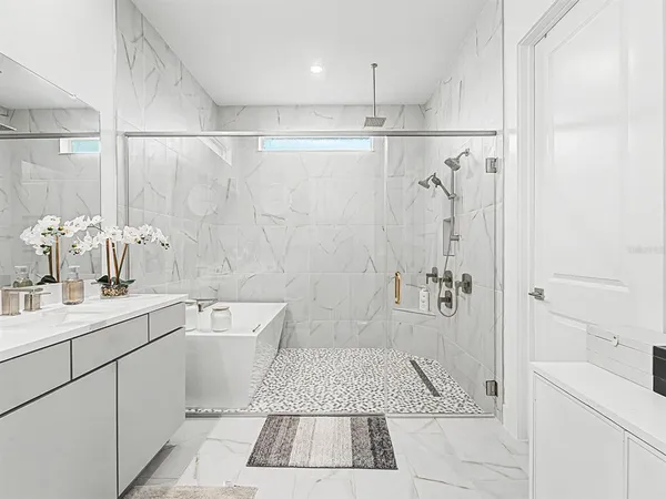 a kitchen with granite countertop white cabinets and stainless steel appliances