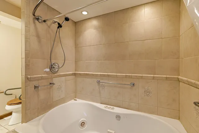 a bathroom with a white bath tub with a shower
