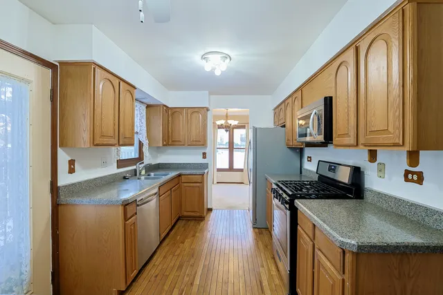 a kitchen with stainless steel appliances granite countertop a sink stove microwave and cabinets