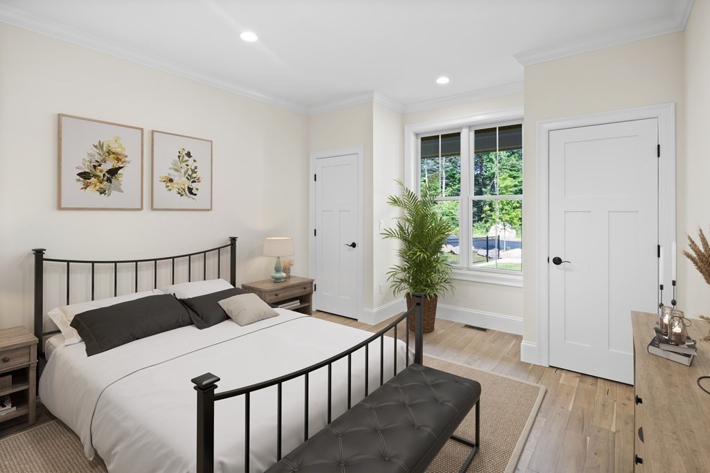 5 Isabella Circle Canton, MA 02021 - Photo 15 of 24 a bedroom with a bed and a potted plant