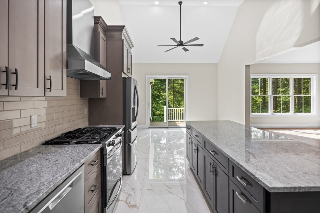 5 Isabella Circle Canton, MA 02021 - Photo 6 of 24 a kitchen that has a sink a stove and a wooden floor