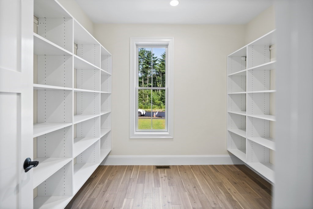 5 Isabella Circle Canton, MA 02021 - Photo 8 of 24 a view of an empty room with a window and wooden floor