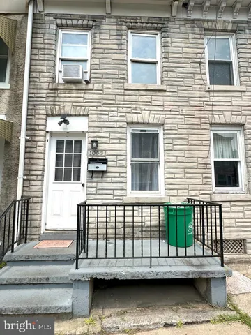a view of a brick house with many windows