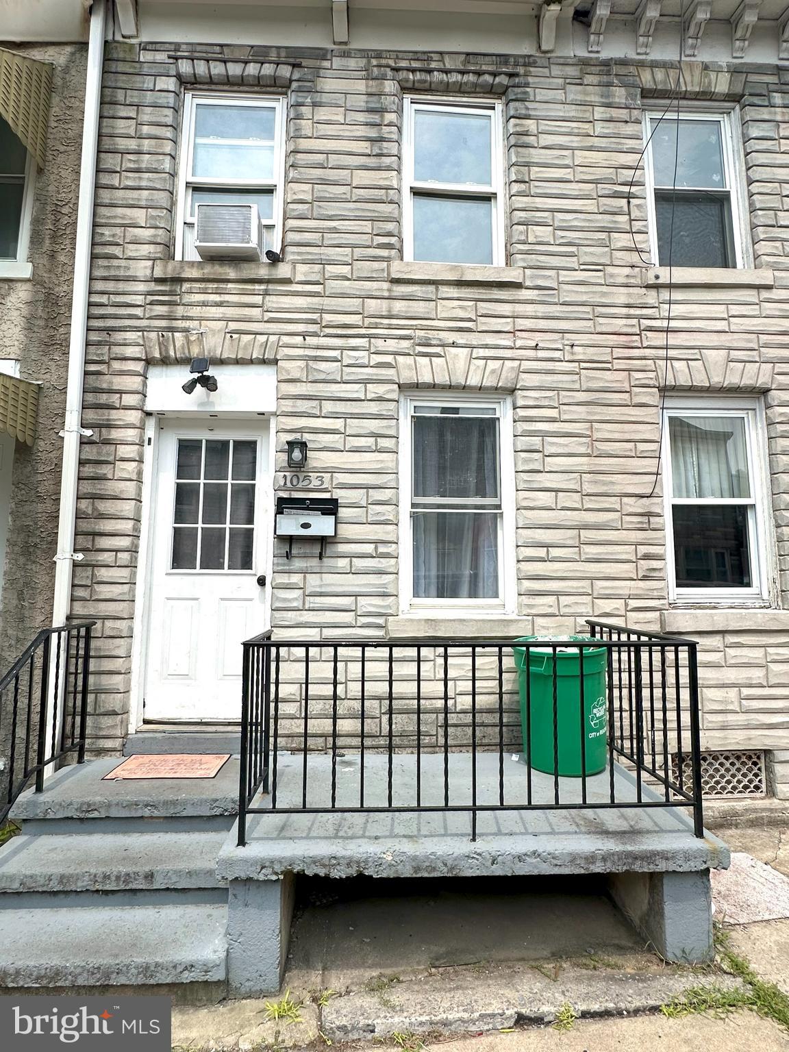 a view of a brick house with many windows