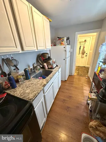 a kitchen with sink refrigerator and window