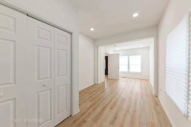 a view of an empty room with wooden floor