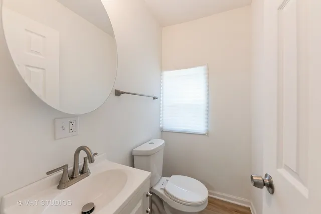 a bathroom with a sink a toilet and mirror