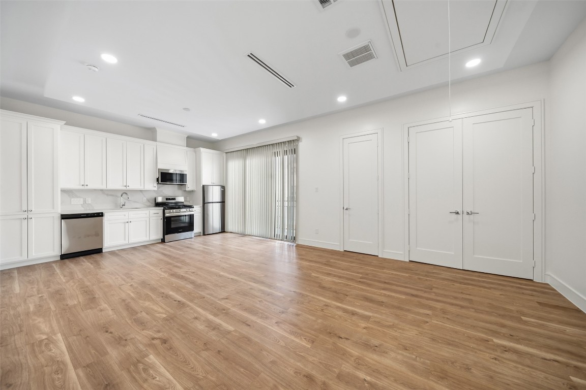 1839 Colquitt Street Houston, TX 77098 - Photo 18 of 19 a view of a kitchen with a sink and dishwasher a refrigerator with wooden floor