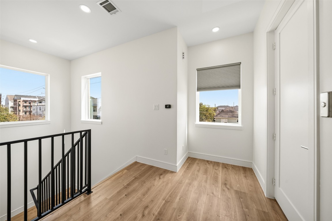 1839 Colquitt Street Houston, TX 77098 - Photo 5 of 19 a view of hallway with wooden floor