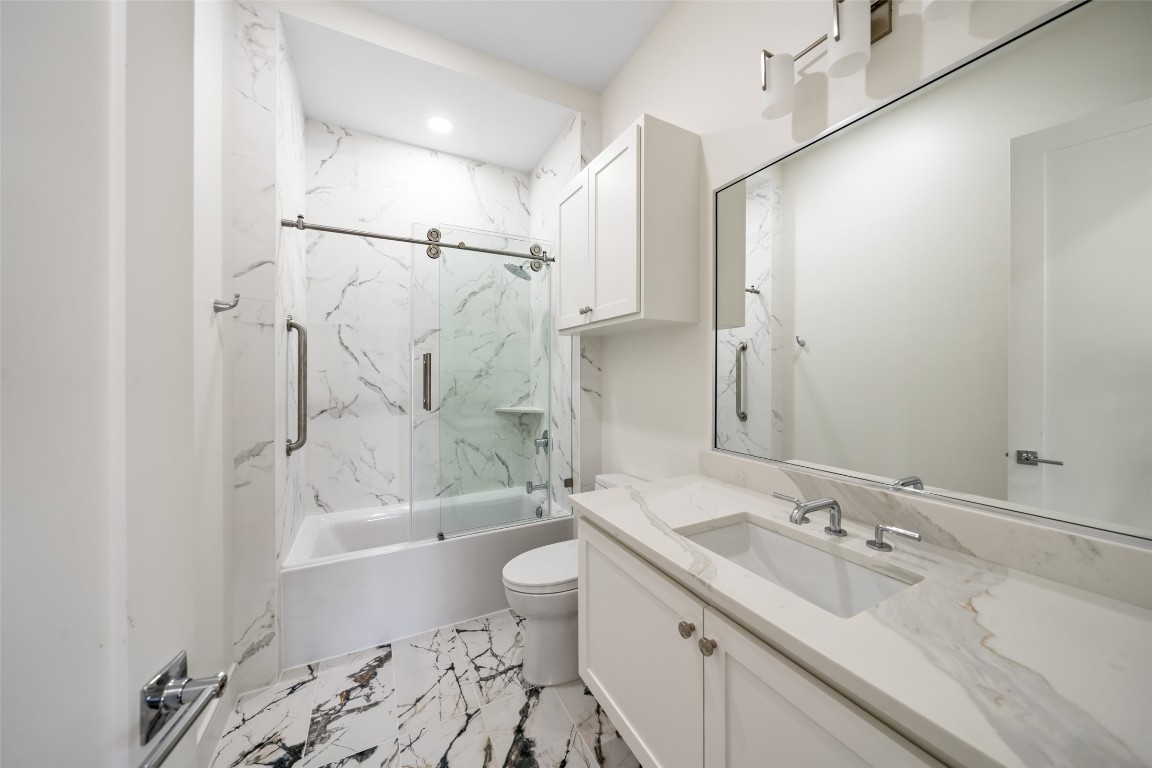 1839 Colquitt Street Houston, TX 77098 - Photo 9 of 19 a bathroom with a bathtub shower sink mirror and toilet