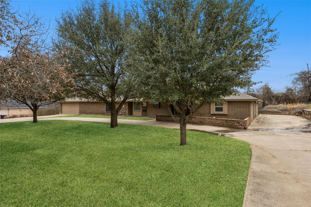 116 Timberview Court Burleson, TX 76028 - Photo 2 of 37 a view of a backyard with large trees