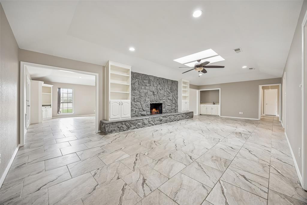 116 Timberview Court Burleson, TX 76028 - Photo 5 of 37 a view of a livingroom with a fireplace and a chandelier