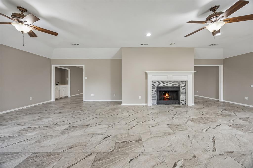 116 Timberview Court Burleson, TX 76028 - Photo 9 of 37 a view of empty room with fireplace and fan