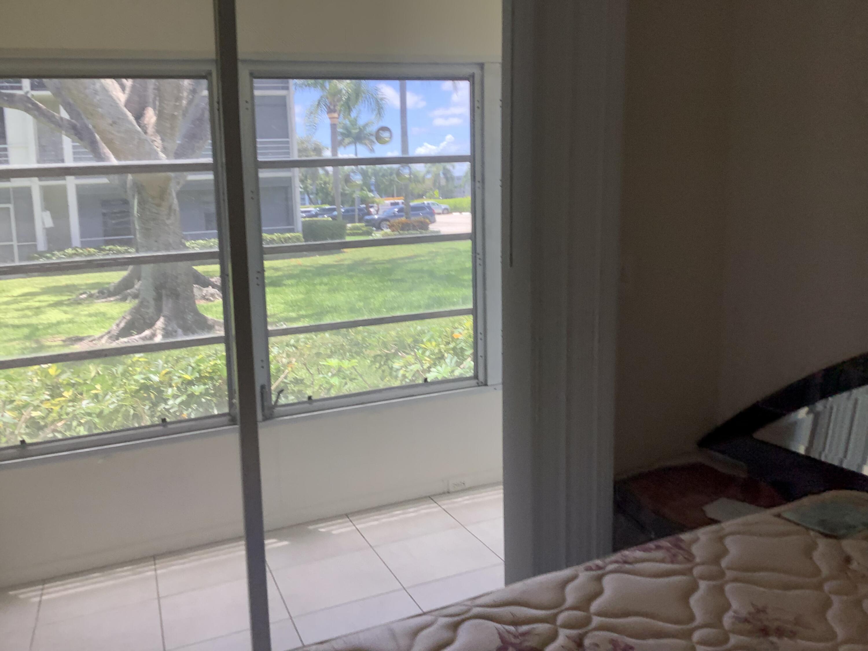 560 Fanshaw North, Unit 560 Boca Raton, FL 33434 - Photo 24 of 26 a bedroom with a bed and a window