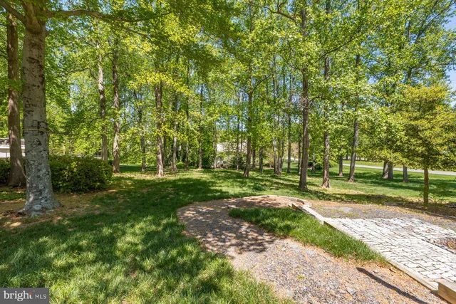 a view of a chair and table in backyard of the house