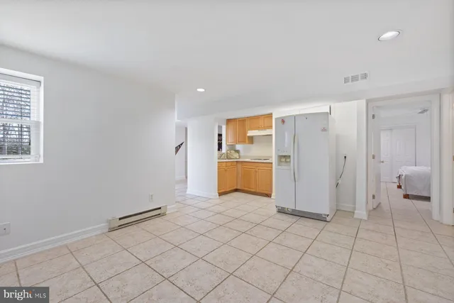 a view of a kitchen with a sink and a refrigerator