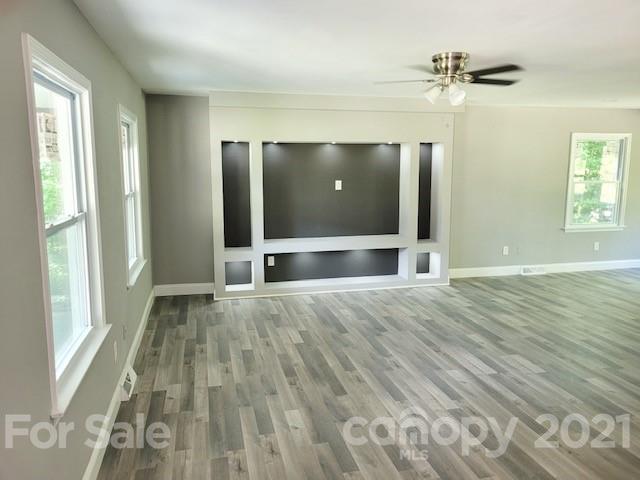 580 Coley Road Salisbury, NC 28146 - Photo 4 of 14 an empty room with wooden floor and windows