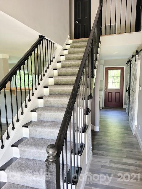 580 Coley Road Salisbury, NC 28146 - Photo 5 of 14 a view of staircase with lots of frames on wall and wooden floor