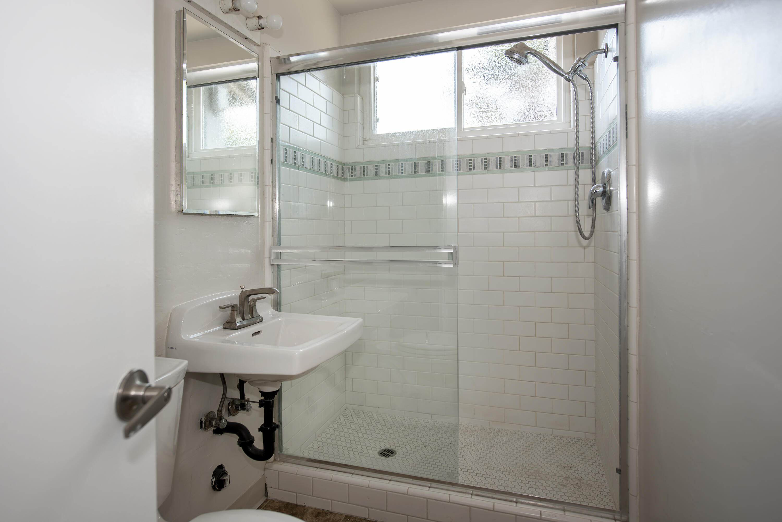 6237 Momouth Avenue Goleta, CA 93117 - Photo 15 of 20 a bathroom with a shower and mirror
