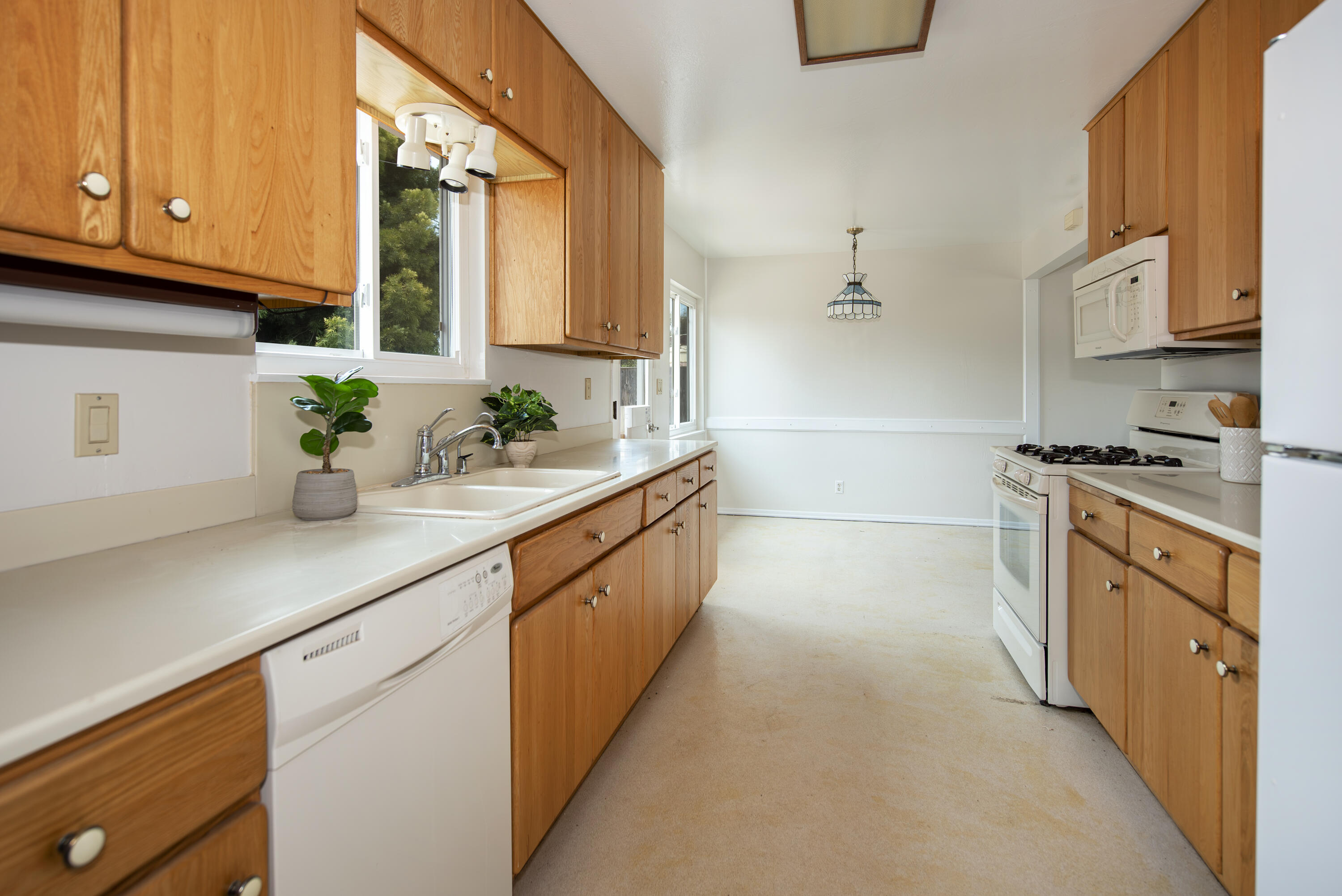 6237 Momouth Avenue Goleta, CA 93117 - Photo 8 of 20 a kitchen with stainless steel appliances a sink stove and cabinets