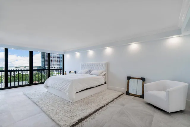 a bedroom with a bed and a view of kitchen