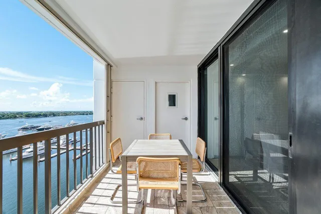 a view of a house with pool and chairs