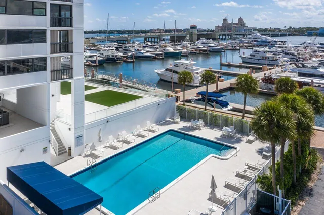 a view of a backyard with a patio and swimming pool