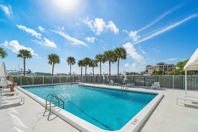 a living room with furniture kitchen view and a large window