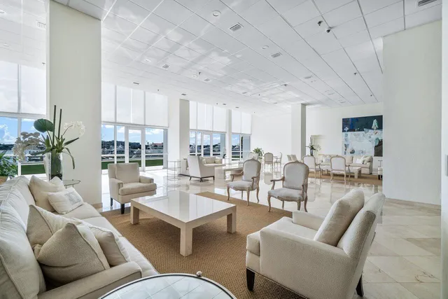 a living room with furniture and large windows