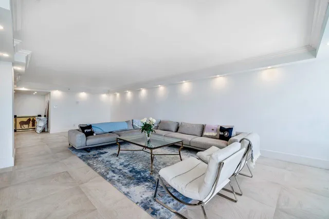 a living room with furniture and kitchen view
