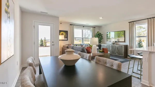 a living room with fireplace furniture and a large window