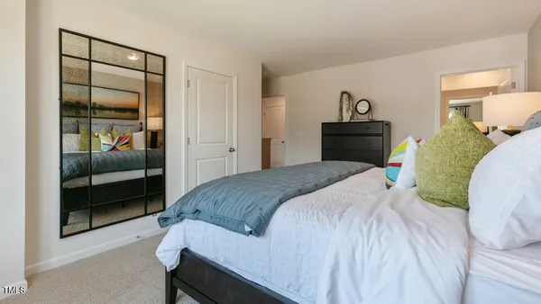 a bedroom with a bed and a painting on the wall