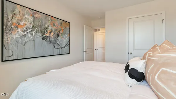 a bedroom with a bed and wall painting