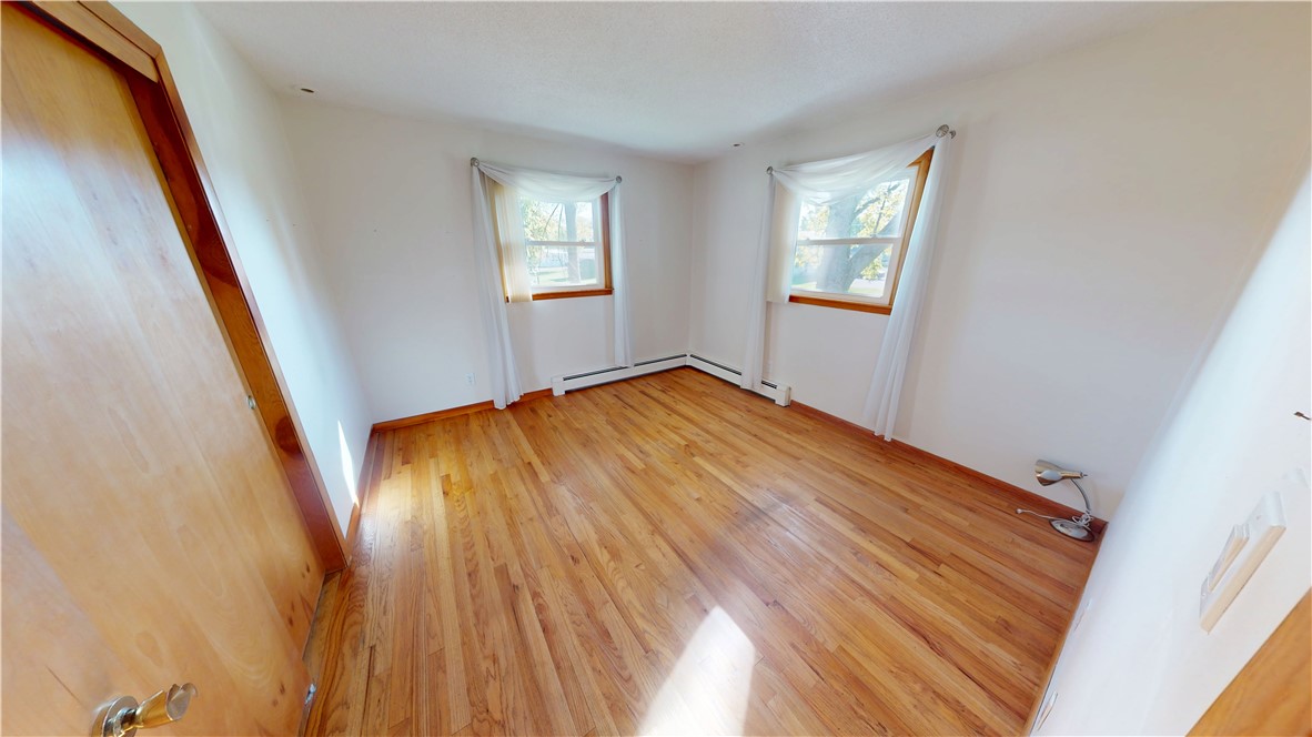 412 Panola Street Georgetown, IL 61846 - Photo 31 of 42 a view of an empty room with wooden floor and a window