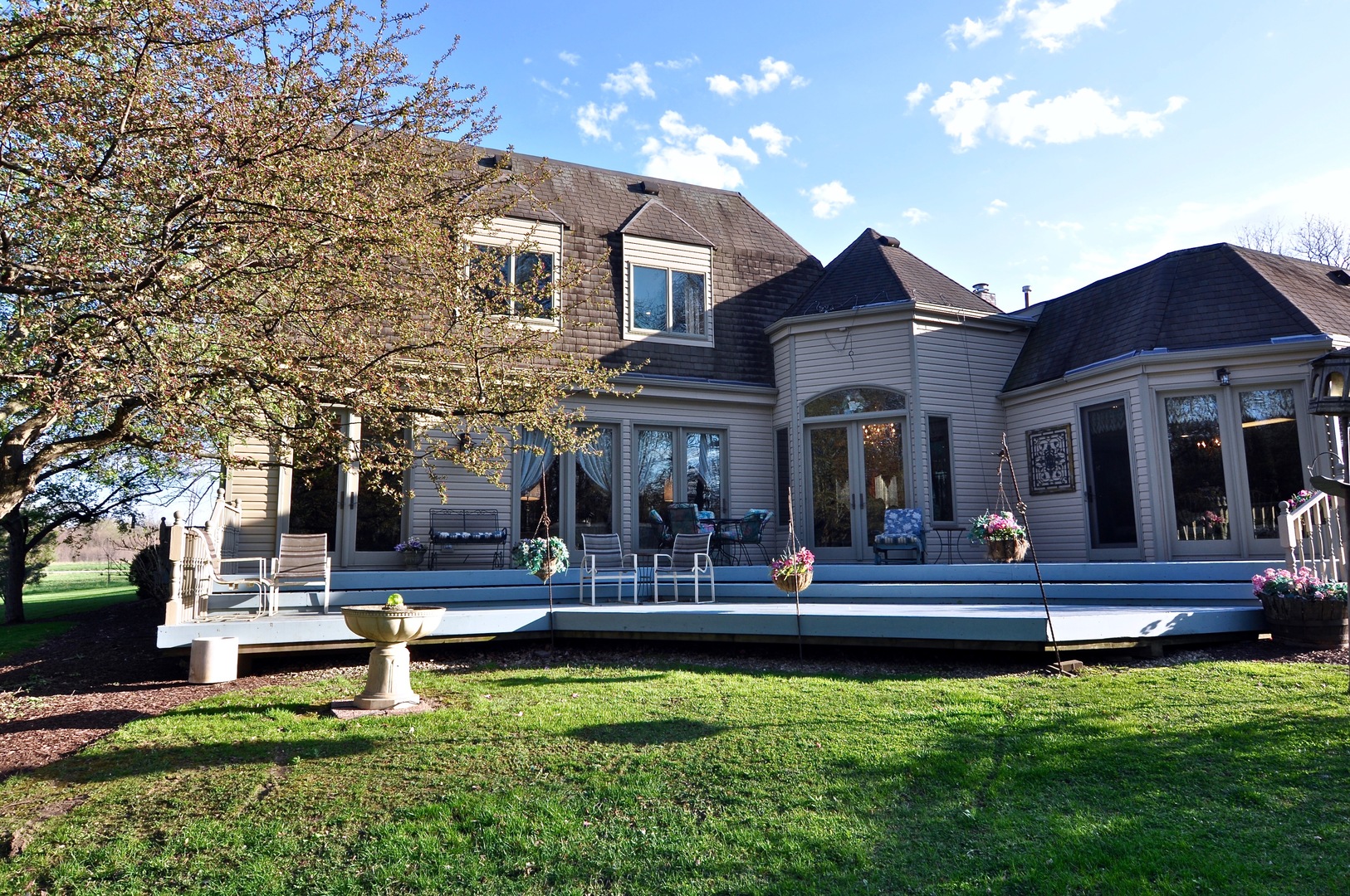 16161 Whipple Road Sycamore, IL 60178 - Photo 41 of 45 a front view of a house with a yard table and chairs