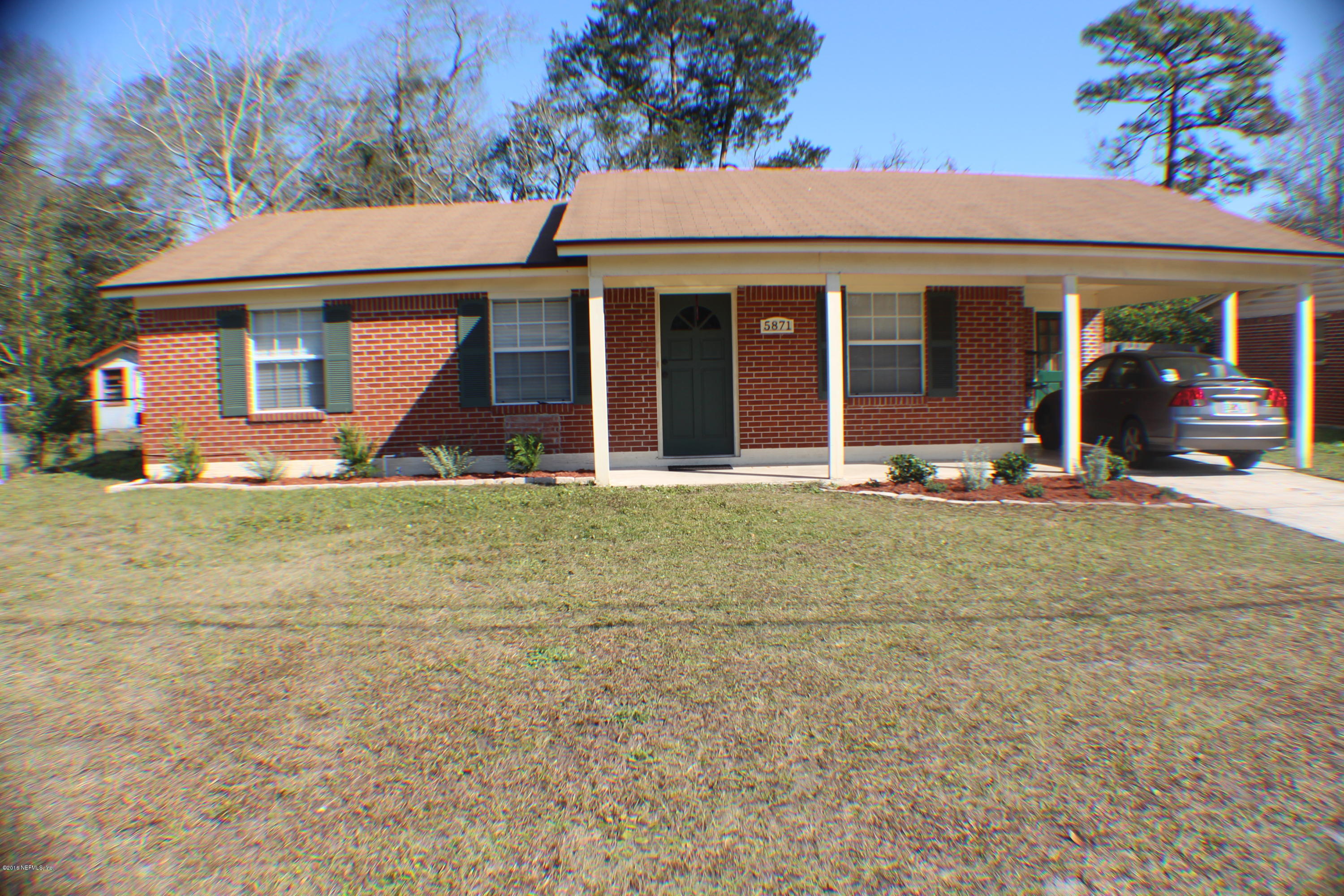 5871 Ridgeway Road East Jacksonville, FL 32244 - Photo 1 of 19 a front view of a house with a garden and trees