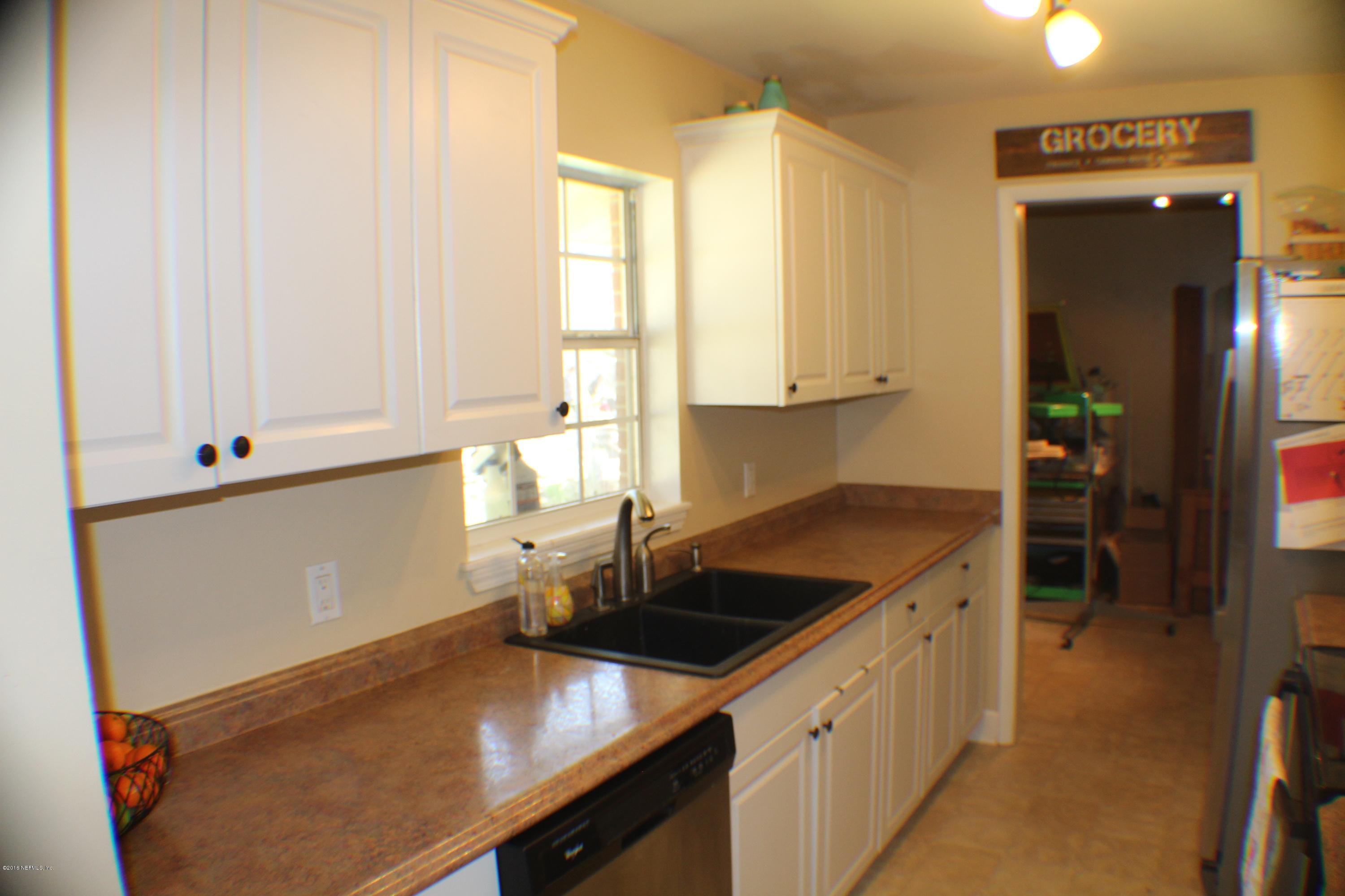 5871 Ridgeway Road East Jacksonville, FL 32244 - Photo 11 of 19 a kitchen that has a sink and a stove