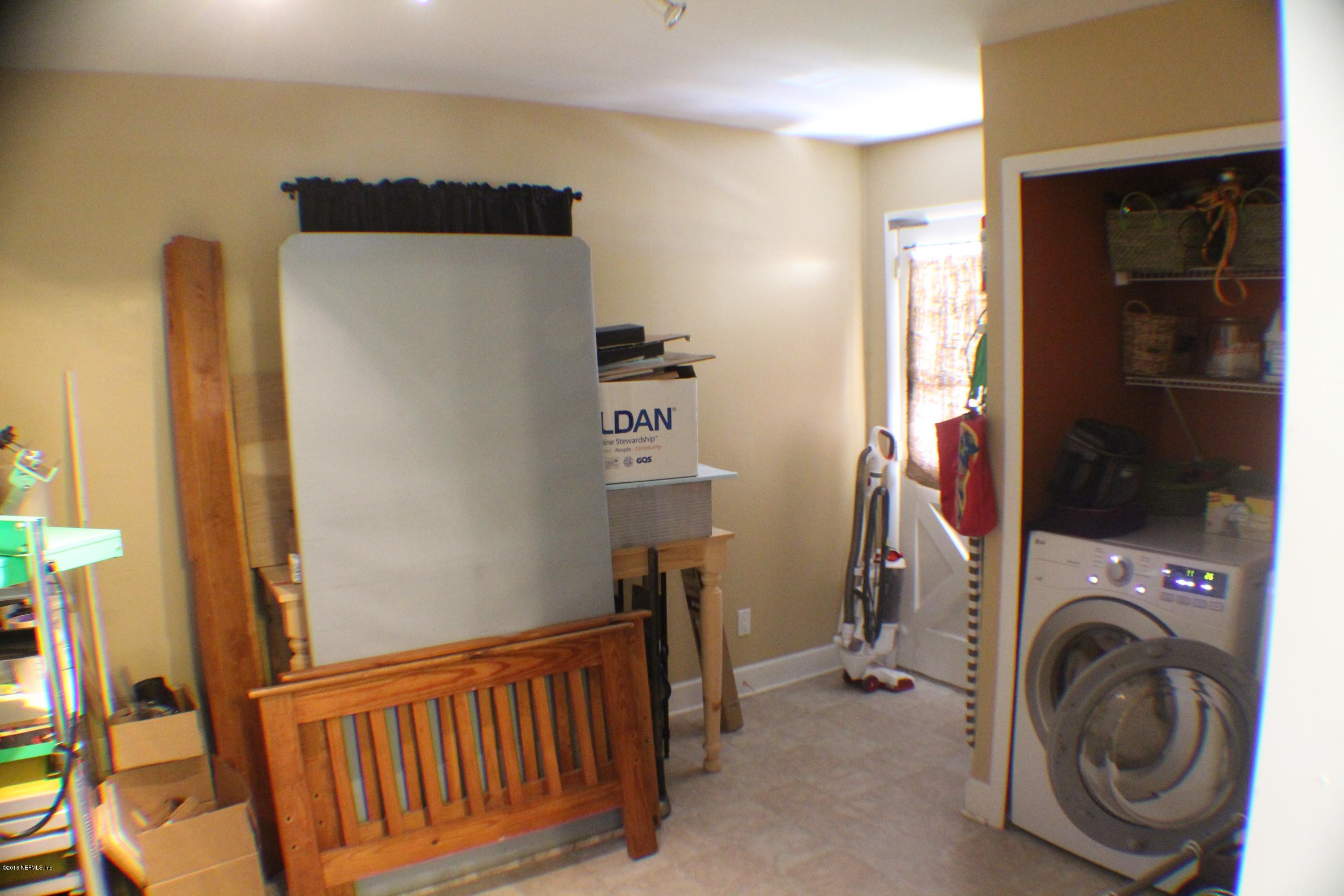 5871 Ridgeway Road East Jacksonville, FL 32244 - Photo 12 of 19 a view of a bedroom with washer and dryer