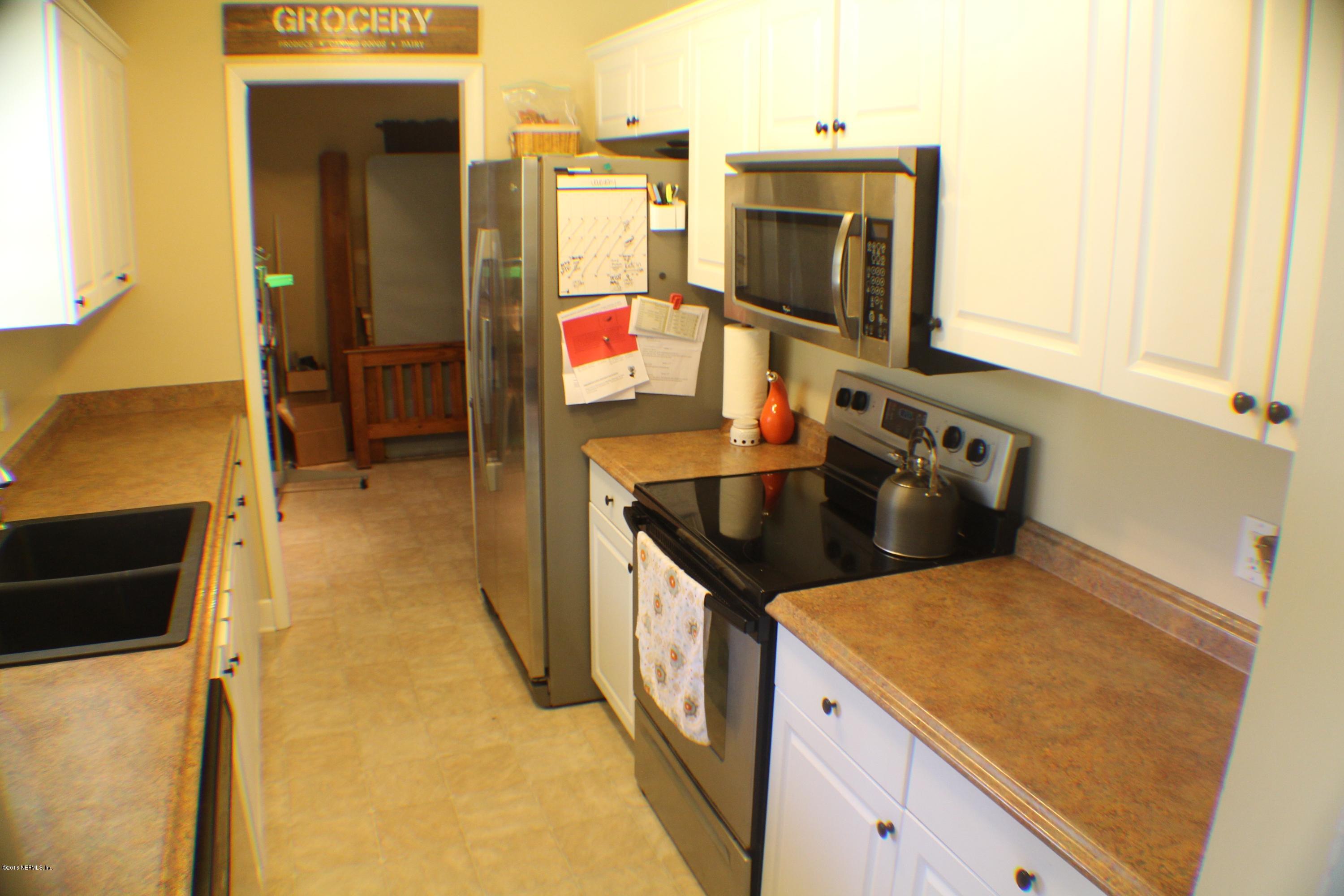 5871 Ridgeway Road East Jacksonville, FL 32244 - Photo 14 of 19 a kitchen with a sink stove and cabinets