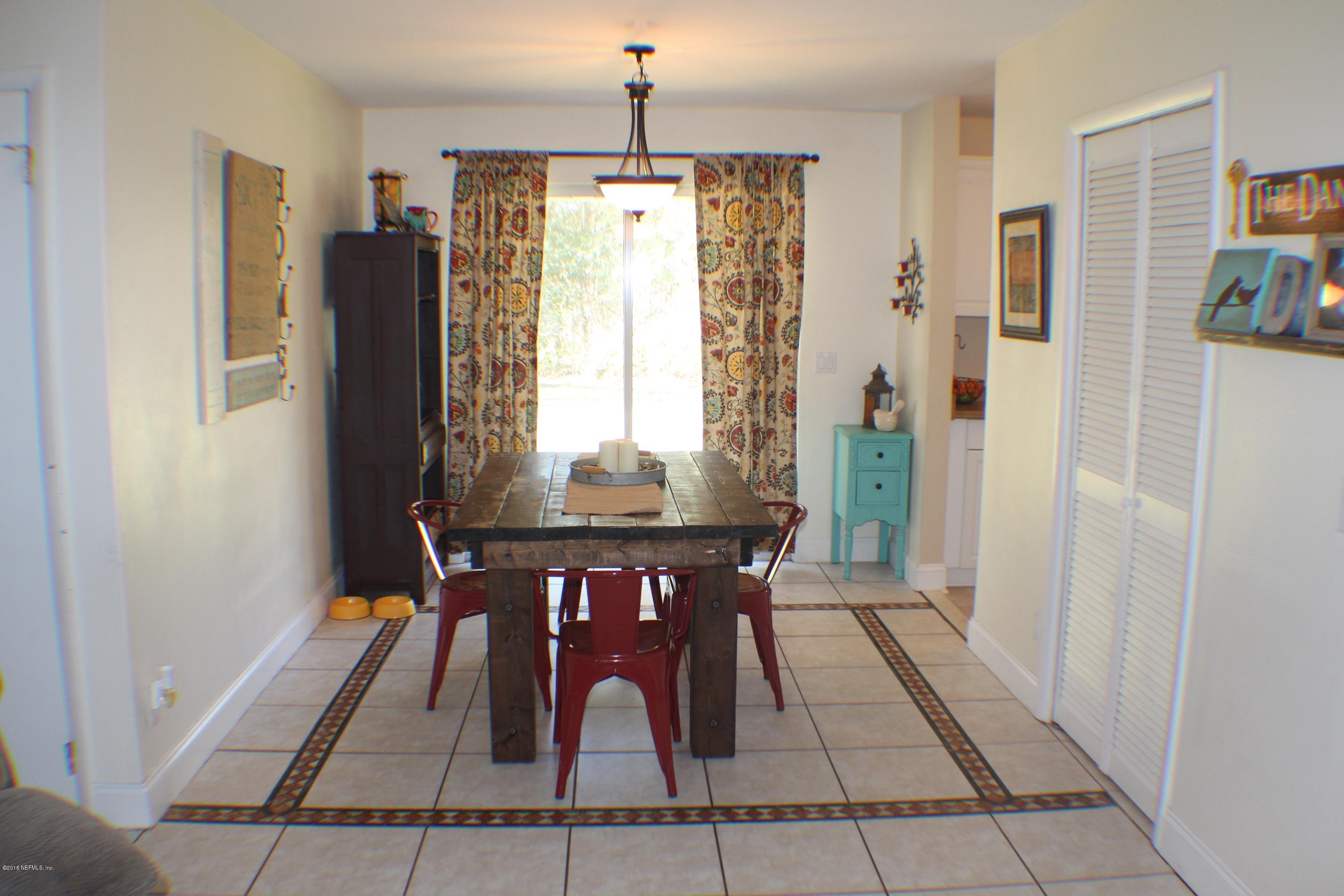 5871 Ridgeway Road East Jacksonville, FL 32244 - Photo 15 of 19 a view of a dining room with furniture window and wooden floor