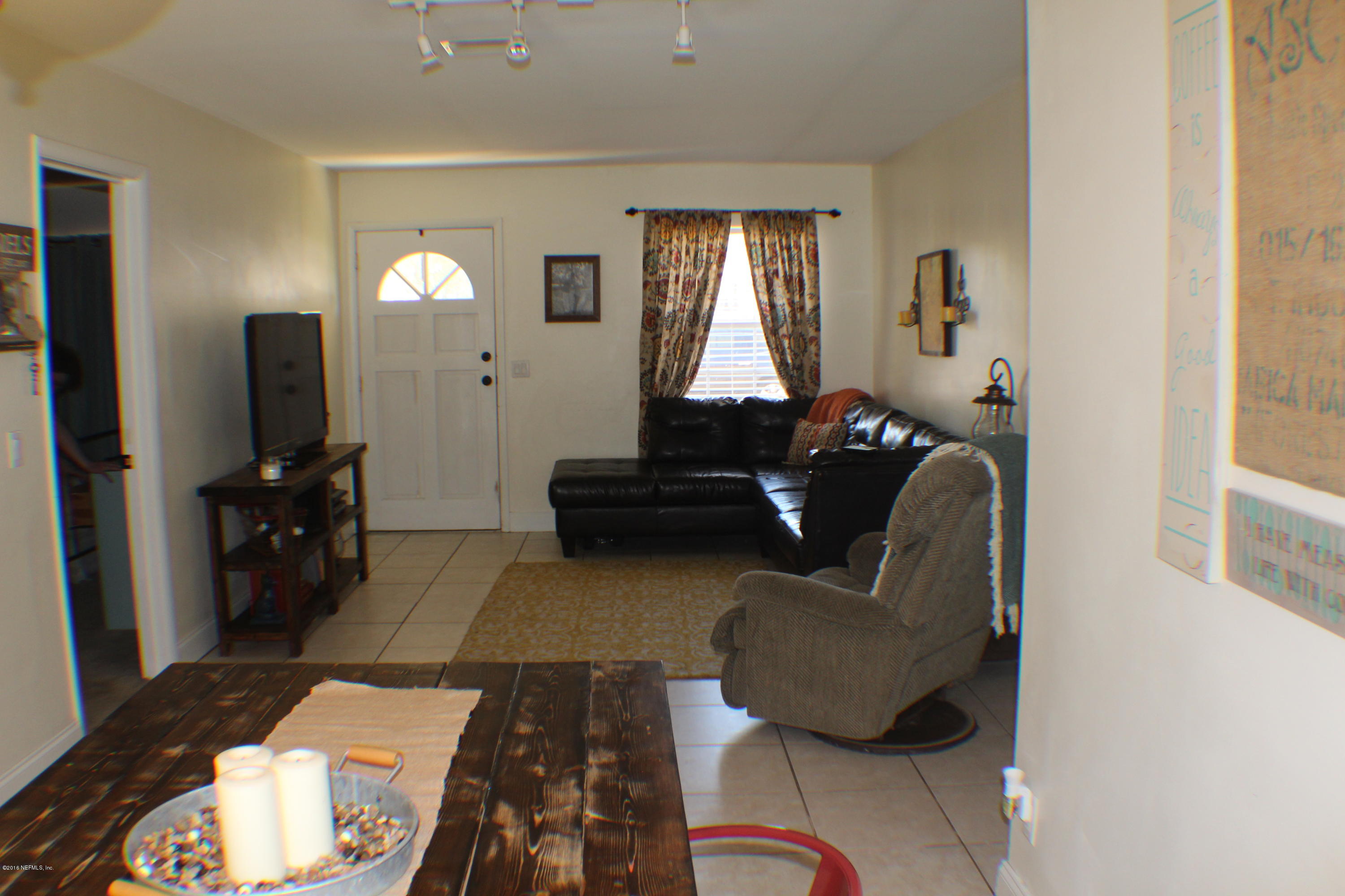 5871 Ridgeway Road East Jacksonville, FL 32244 - Photo 16 of 19 a living room with furniture and a flat screen tv