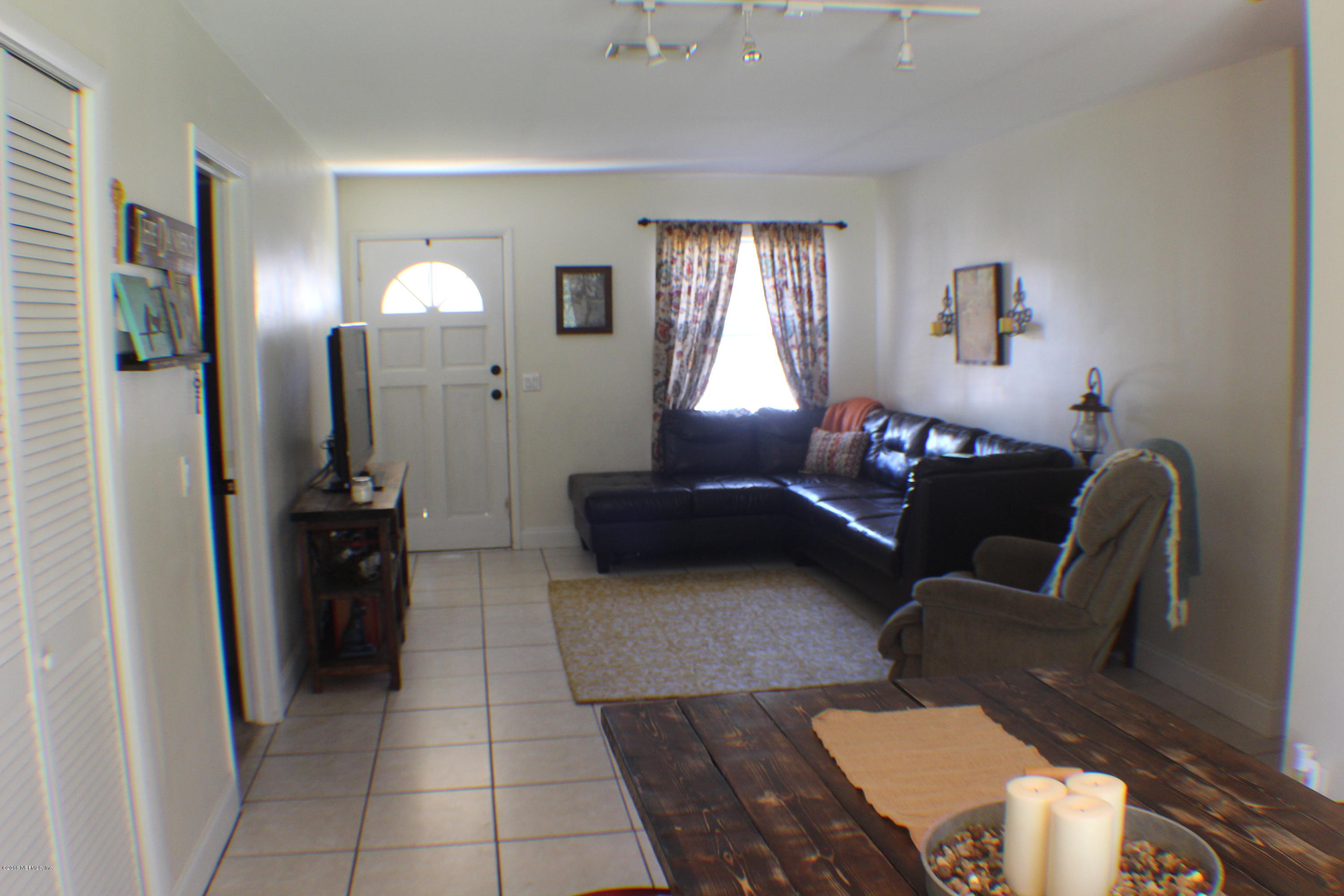 5871 Ridgeway Road East Jacksonville, FL 32244 - Photo 17 of 19 a living room with furniture and a mirror