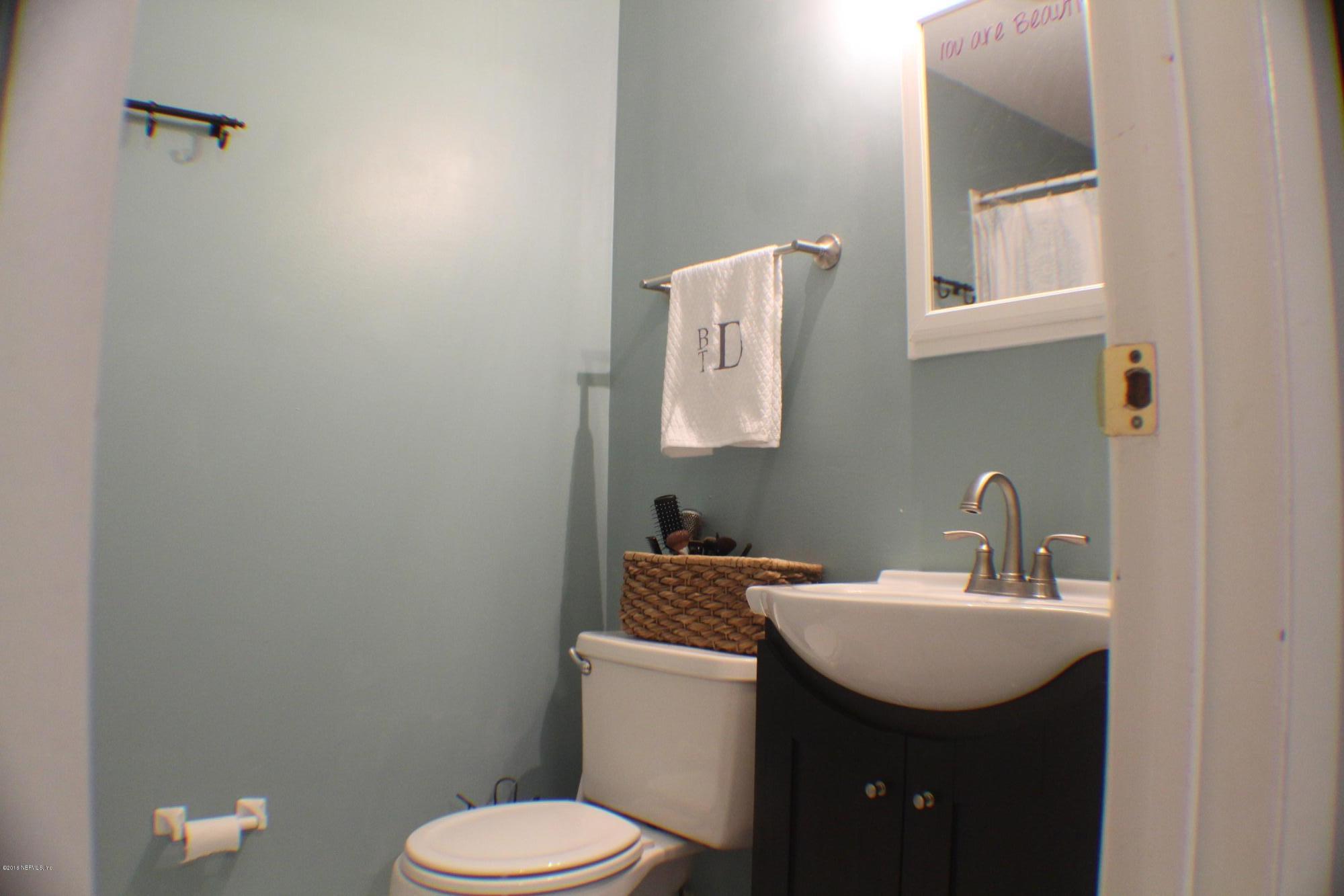 5871 Ridgeway Road East Jacksonville, FL 32244 - Photo 3 of 19 a bathroom with a sink toilet and mirror