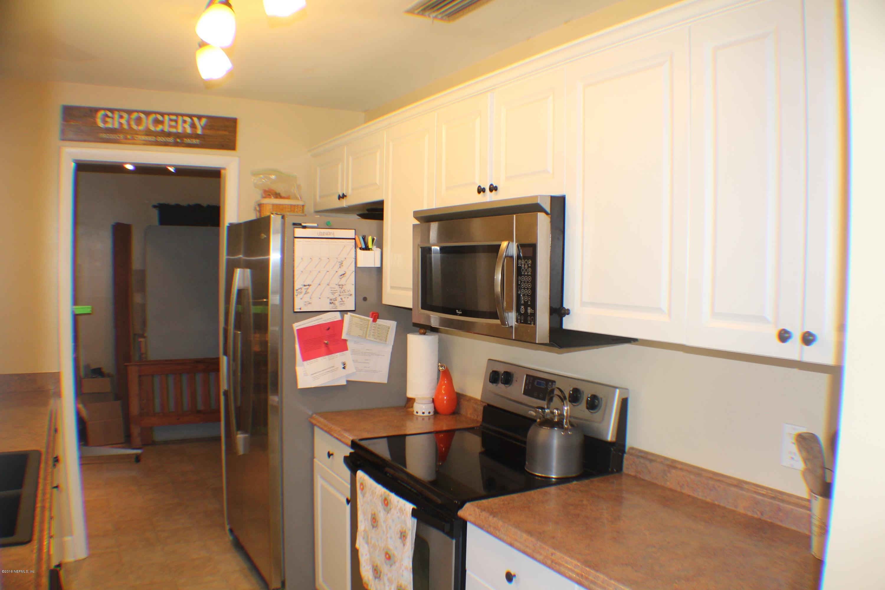 5871 Ridgeway Road East Jacksonville, FL 32244 - Photo 9 of 19 a kitchen with stainless steel appliances granite countertop a sink and a stove