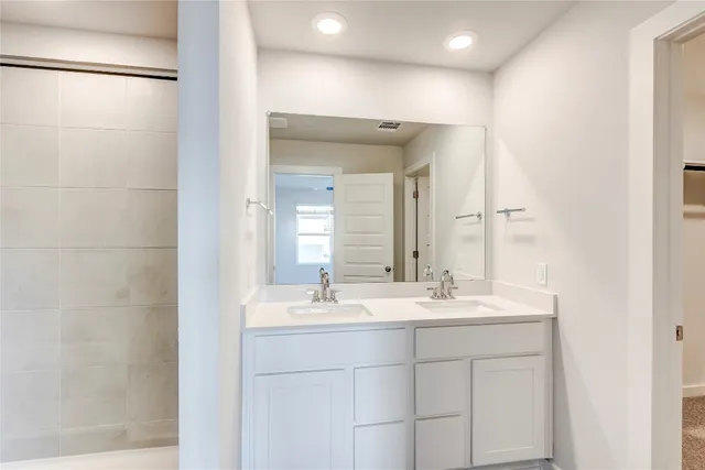 a bathroom with a double vanity sink mirror and double