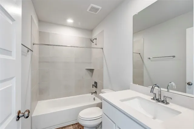 a bathroom with a sink a toilet and a bathtub